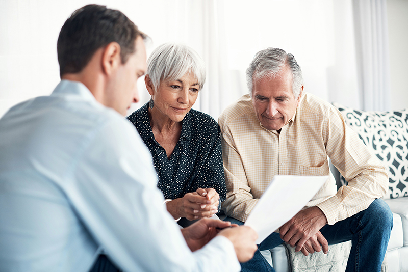 senior aged couple learning about the cost of senior living